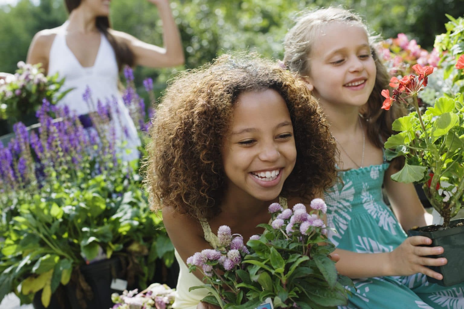 Allergy Symptoms From Plants and Grasses Two children in a garden about to experience allergy symptoms