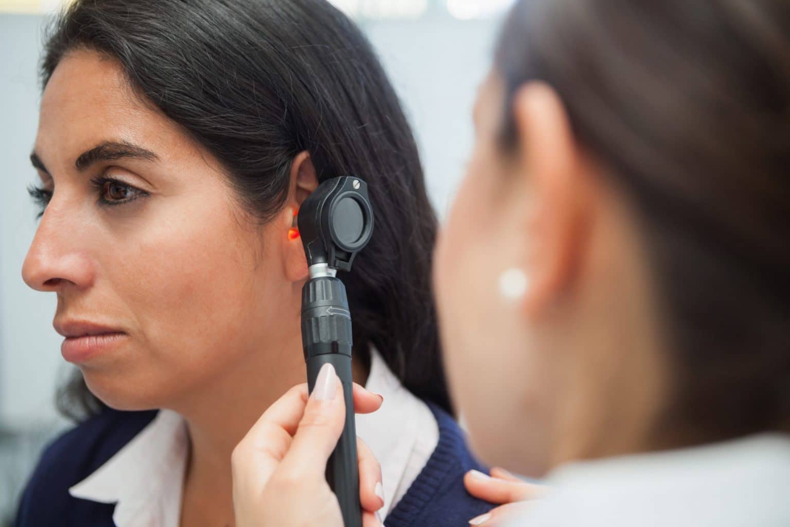 woman getting ear checked with otoscope by an ENT