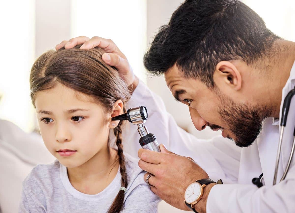 Ear Tube Treatment Checkup Doctor looking into child's ear using a medical device and determining if ear tubes are the right procedure