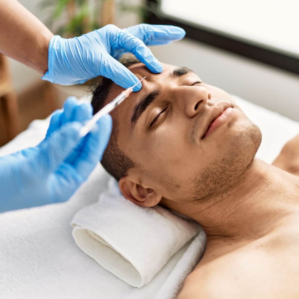 close up image of a man receiving an injectable treatment from a cosmetic surgeon